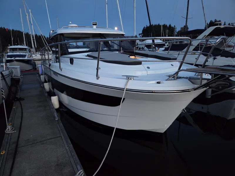 Slide: The Image of 2023 Jeanneau NC Weekender 1095 docked at marina during twilight. - 3