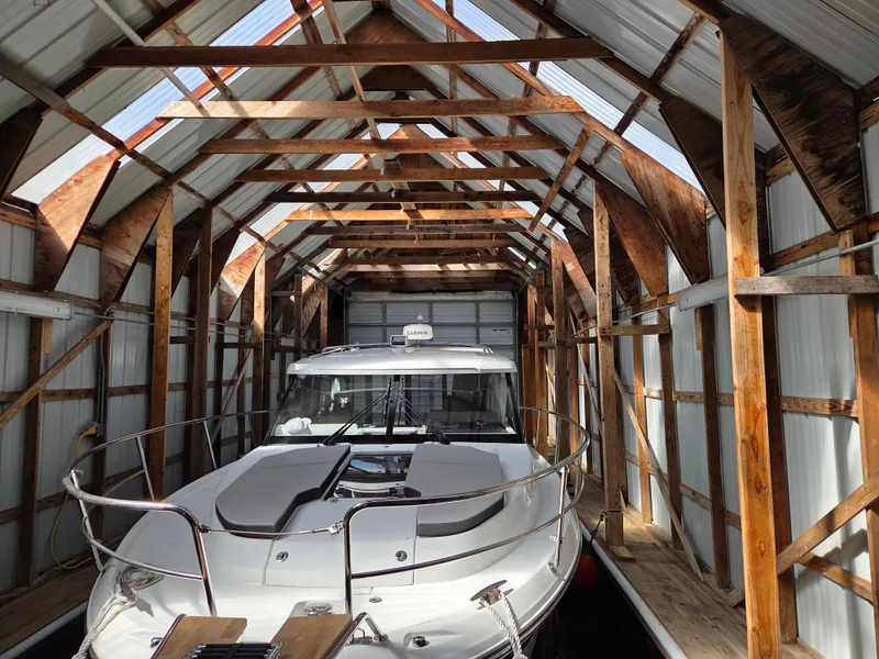 Slide: The Image of 2023 Jeanneau NC Weekender 1095 docked in a wooden boathouse. - 4