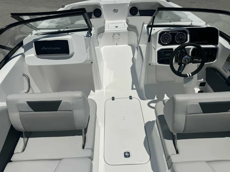 Slide: The Image of 2026 Hurricane SunDeck 2050 OB boat on calm water under cloudy sky. - 2