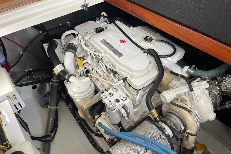 Slide: The Image of Engine compartment of a 2018 Beneteau Swift Trawler 35, showcasing detailed mechanical components. - 102