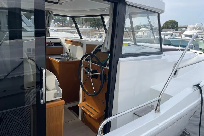 Slide: The Image of 2018 Beneteau Swift Trawler 35 interior view with steering wheel and sink. - 15