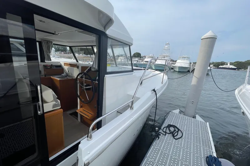 Slide: The Image of 2018 Beneteau Swift Trawler 35 docked, showcasing interior helm and exterior design. - 16