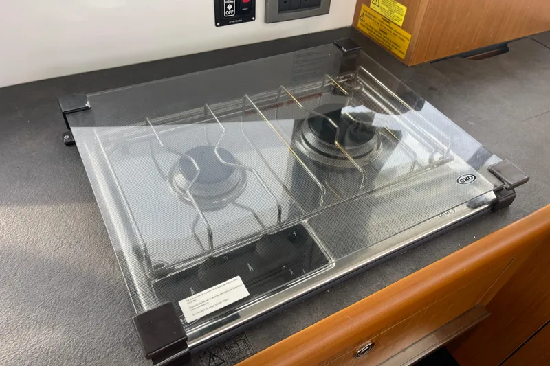 Slide: The Image of Gas stove on 2018 Beneteau Swift Trawler 35, featuring protective glass cover. - 23