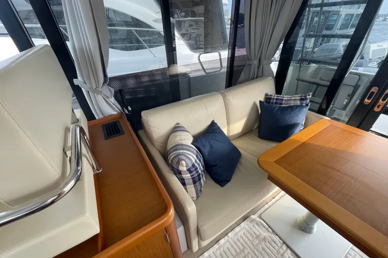 Slide: The Image of Interior of 2018 Beneteau Swift Trawler 35 with cozy seating and wooden table. - 27