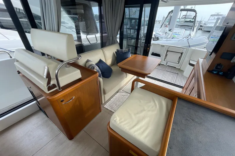 Slide: The Image of Interior of 2018 Beneteau Swift Trawler 35, featuring elegant seating and wooden finishes. - 30