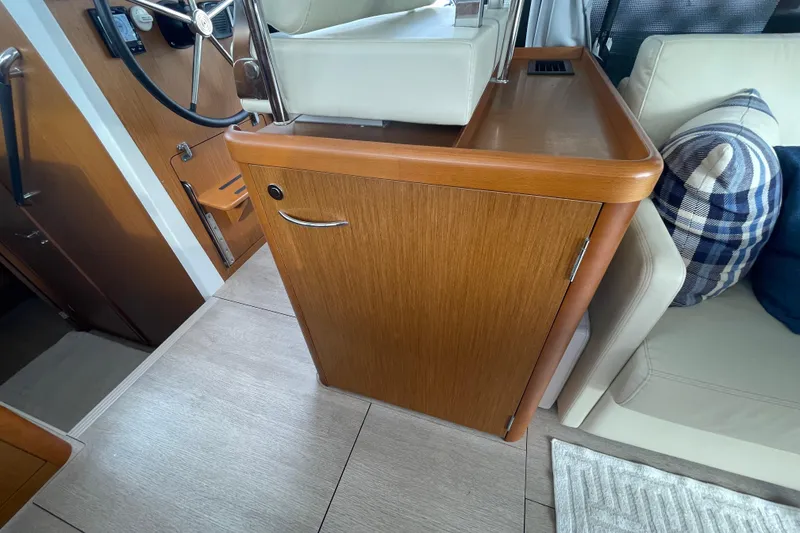 Slide: The Image of Interior of 2018 Beneteau Swift Trawler 35, featuring helm station and seating area. - 31