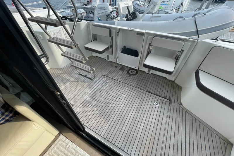 Slide: The Image of 2018 Beneteau Swift Trawler 35 deck with seating and ladder, featuring a modern design. - 36