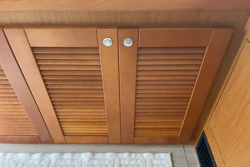 Slide: The Image of Wooden cabinet doors inside a 2018 Beneteau Swift Trawler 35 yacht interior. - 40