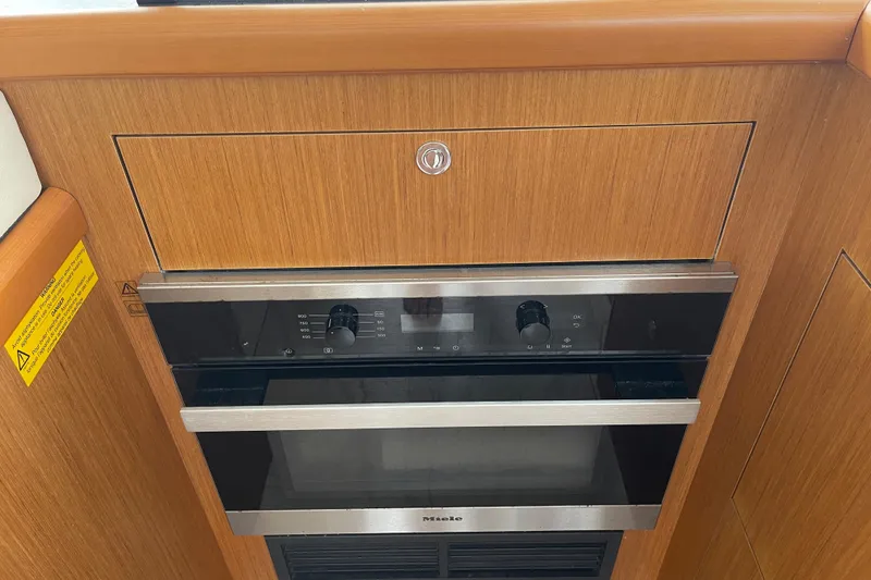 Slide: The Image of Miele oven in 2018 Beneteau Swift Trawler 35 kitchen, wood paneling. - 42