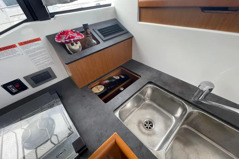 Slide: The Image of 2018 Beneteau Swift Trawler 35 kitchen with sink, stove, and storage. - 44