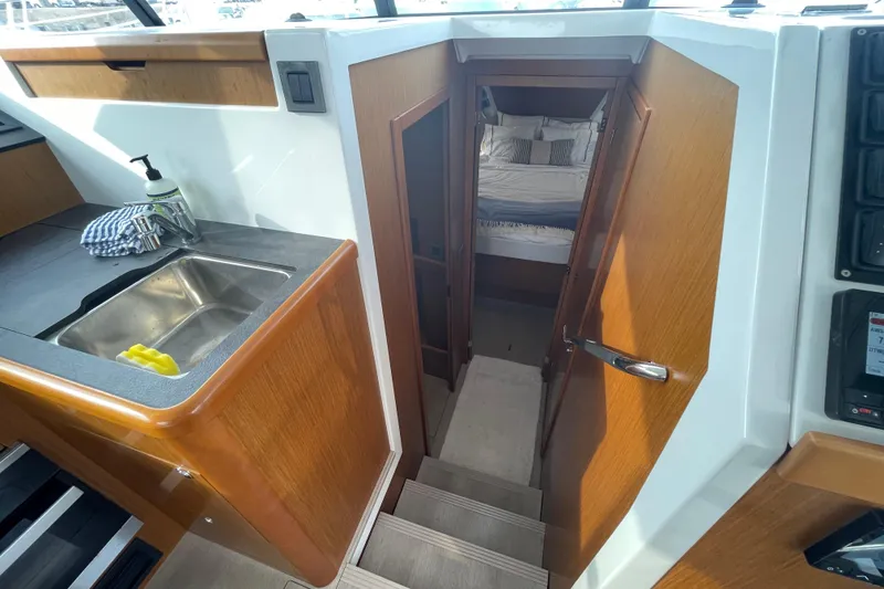 Slide: The Image of 2018 Beneteau Swift Trawler 35 interior with sink, stairs, and bedroom view. - 48