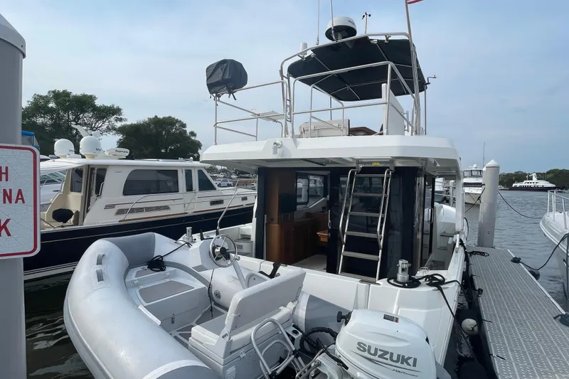Slide: The Image of 2018 Beneteau Swift Trawler 35 docked with inflatable boat and Suzuki motor. - 5