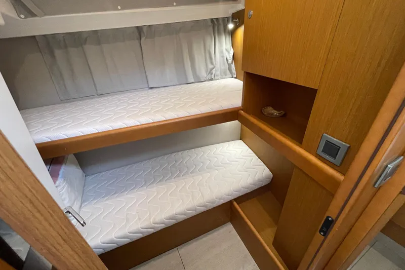 Slide: The Image of 2018 Beneteau Swift Trawler 35 cabin with bunk beds and wooden interior. - 55