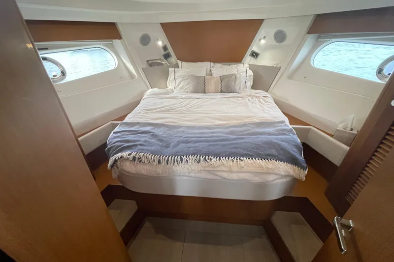 Slide: The Image of 2018 Beneteau Swift Trawler 35 cabin with cozy bed and nautical decor. - 56