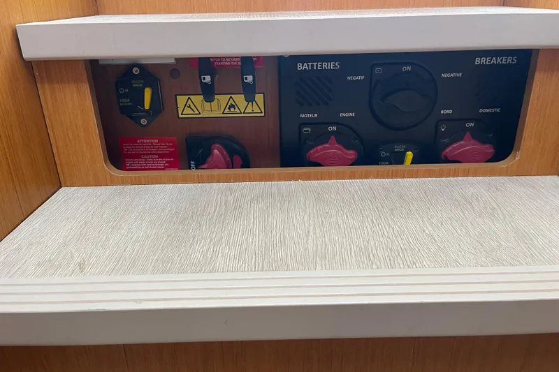 Slide: The Image of Electrical panel of 2018 Beneteau Swift Trawler 35, featuring battery and breaker controls. - 65