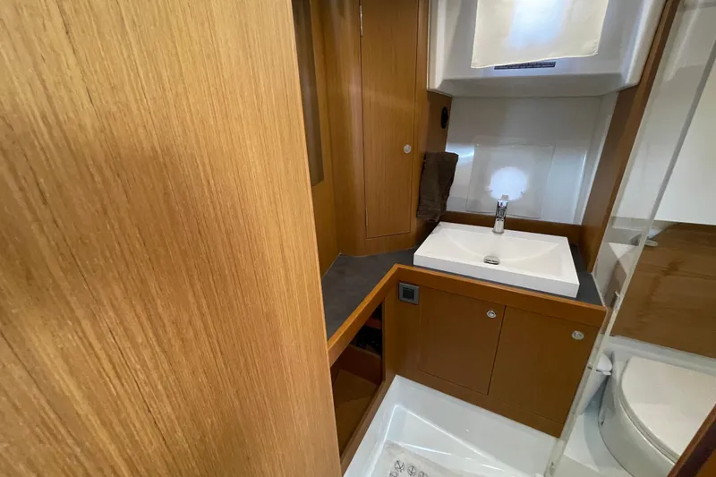 Slide: The Image of 2018 Beneteau Swift Trawler 35 bathroom with wooden cabinetry and modern sink. - 66