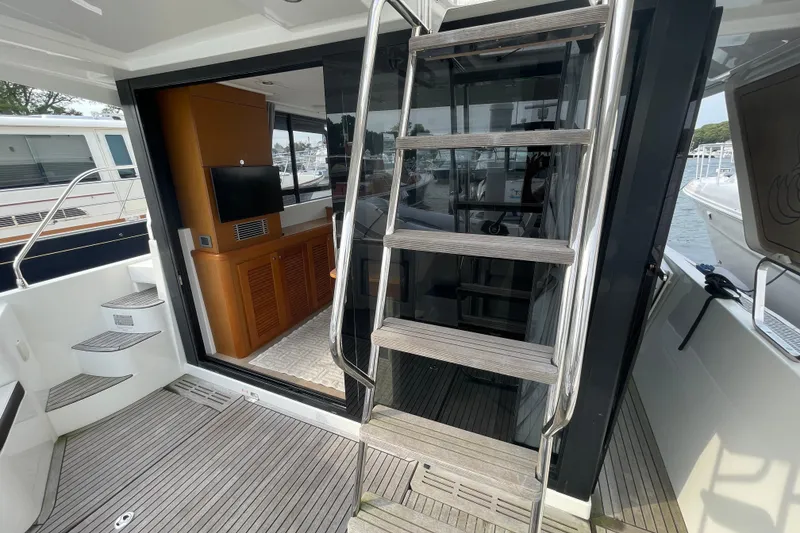 Slide: The Image of 2018 Beneteau Swift Trawler 35 interior with stairs and wooden cabinetry. - 74