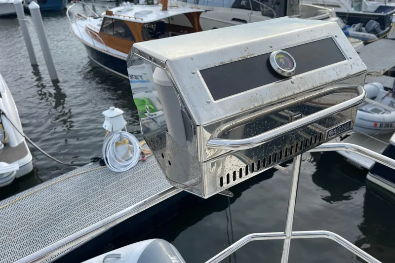 Slide: The Image of Stainless steel grill on a 2018 Beneteau Swift Trawler 35, docked at a marina. - 78