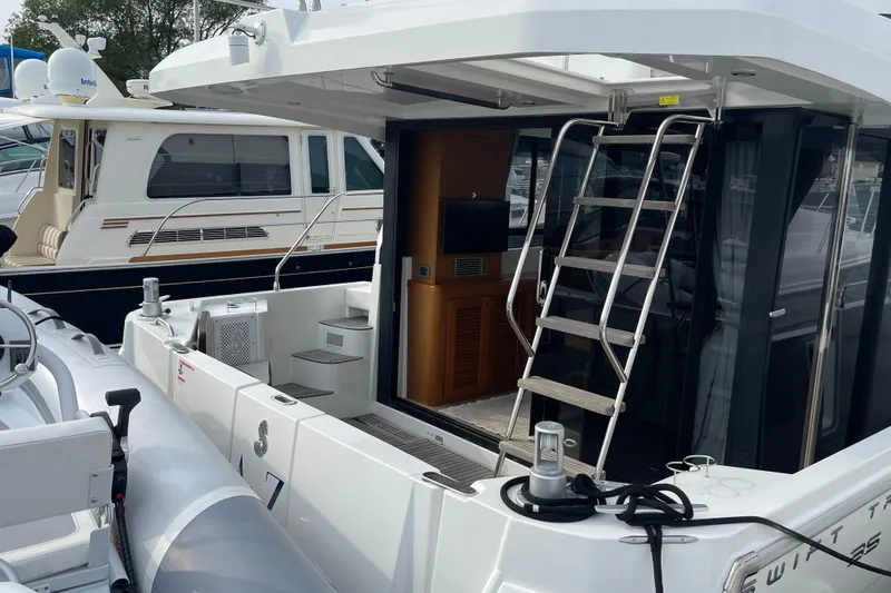 Slide: The Image of 2018 Beneteau Swift Trawler 35, rear view with ladder and deck details. - 8