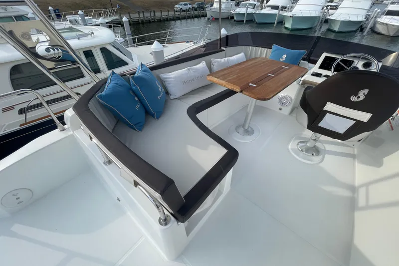 Slide: The Image of 2018 Beneteau Swift Trawler 35 flybridge with seating, table, and helm station. - 80