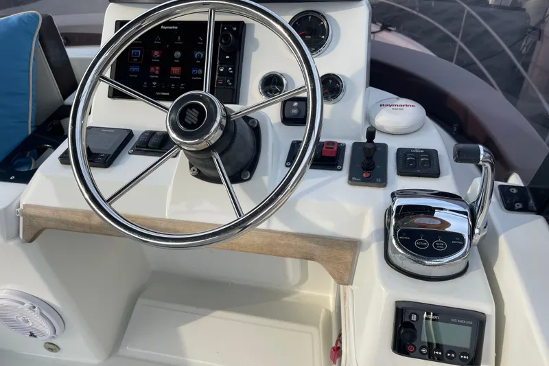 Slide: The Image of 2018 Beneteau Swift Trawler 35 helm with steering wheel and navigation controls. - 87