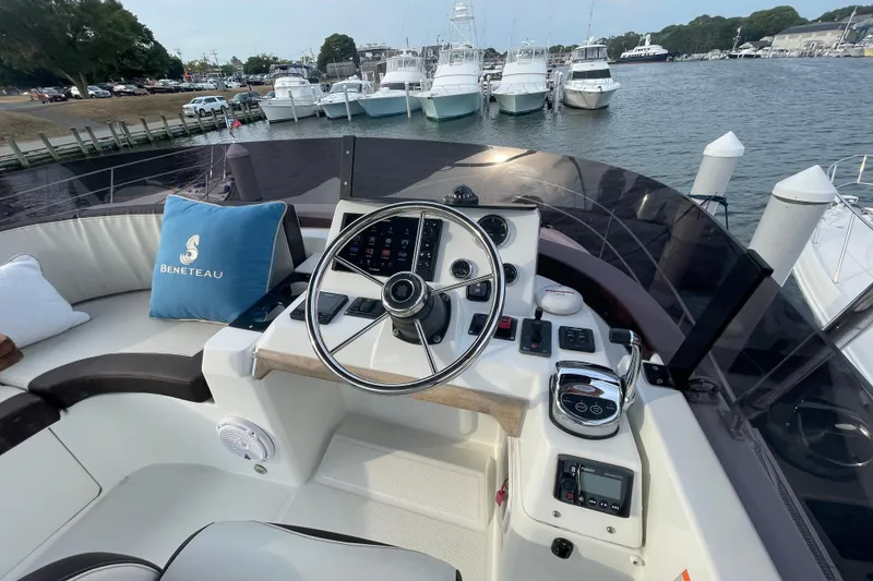 Slide: The Image of Helm of 2018 Beneteau Swift Trawler 35 with marina view in background. - 88