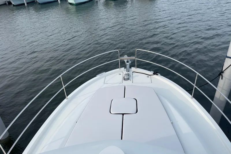 Slide: The Image of 2018 Beneteau Swift Trawler 35 bow view at marina, showcasing sleek design. - 91