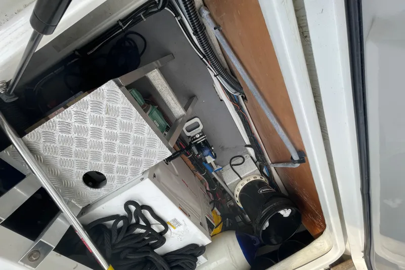 Slide: The Image of Interior view of 2018 Beneteau Swift Trawler 35 engine compartment with equipment and cables. - 95