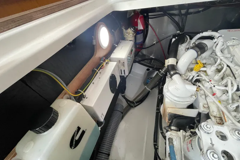 Slide: The Image of Engine room of 2018 Beneteau Swift Trawler 35, showcasing mechanical components and wiring. - 98