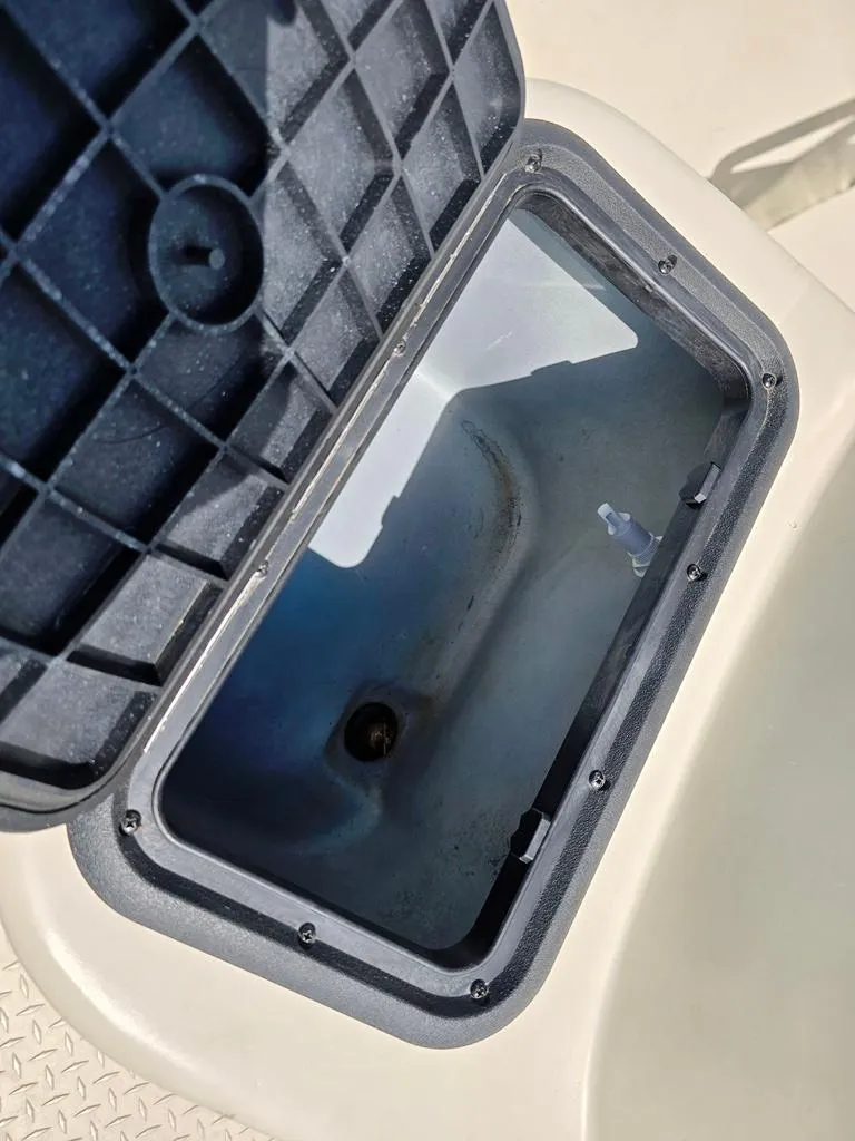 Slide: The Image of Open storage compartment on 2015 SeaArk RX18 Center Console boat. - 12