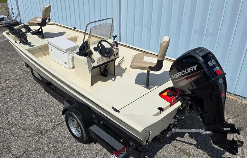 Slide: The Image of 2015 SeaArk RX18 Center Console boat with Mercury 60 outboard motor, parked on a trailer. - 2