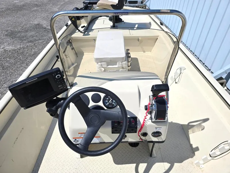 Slide: The Image of 2015 SeaArk RX18 Center Console boat interior with steering wheel and navigation equipment. - 4