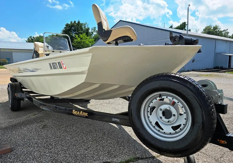 Slide: The Image of 2015 SeaArk RX18 Center Console boat on trailer, parked outdoors under a blue sky. - 9