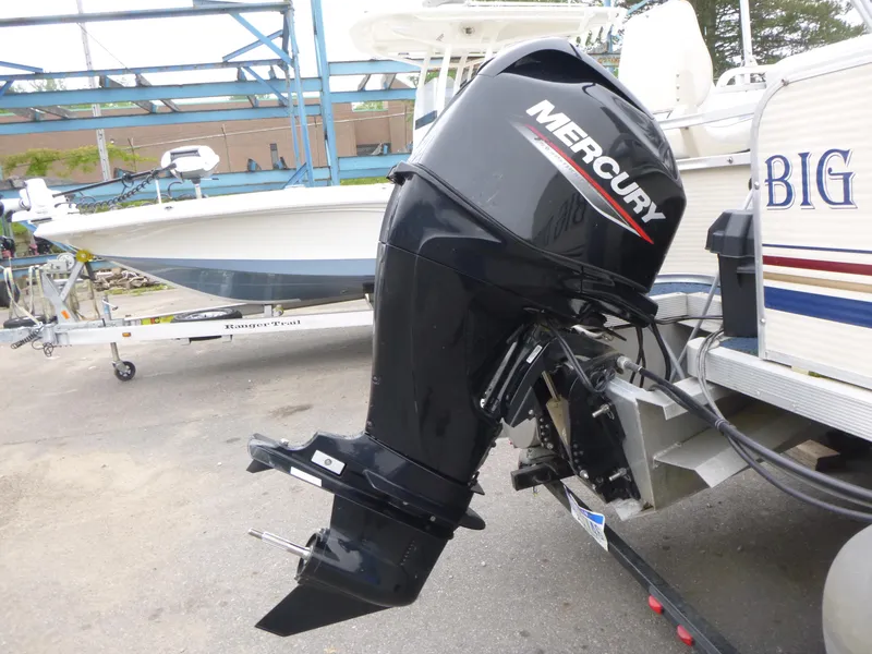 Slide: The Image of Outboard motor on a 2000 Smoker Craft 818 4-Point boat, parked on a trailer. - 13