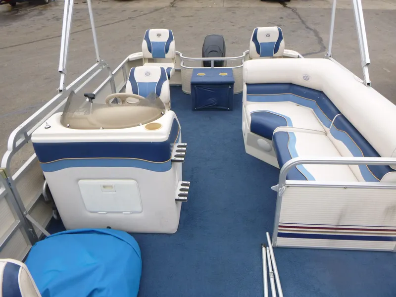 Slide: The Image of 2000 Smoker Craft 818 4-Point pontoon boat interior with blue and white seating. - 5