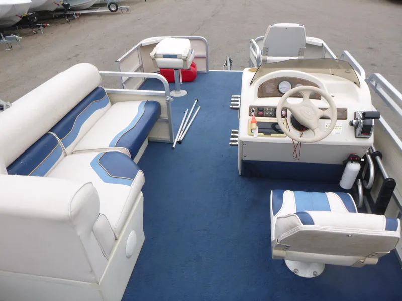 Slide: The Image of 2000 Smoker Craft 818 4-Point pontoon boat interior with blue and white seating. - 6