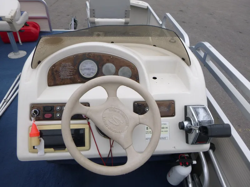 Slide: The Image of Steering console of a 2000 Smoker Craft 818 4-Point boat with controls and gauges. - 8