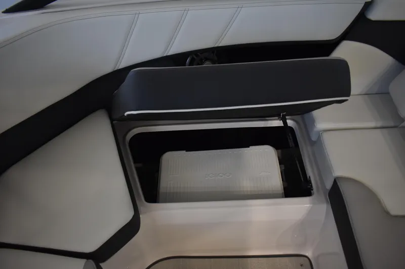 Slide: The Image of 2026 Regal 2000 ES boat interior with open storage compartment and cooler. - 9