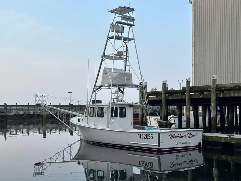 The Image of 2003 BHM Sport Fish boat docked at a marina, calm water reflection. - 0