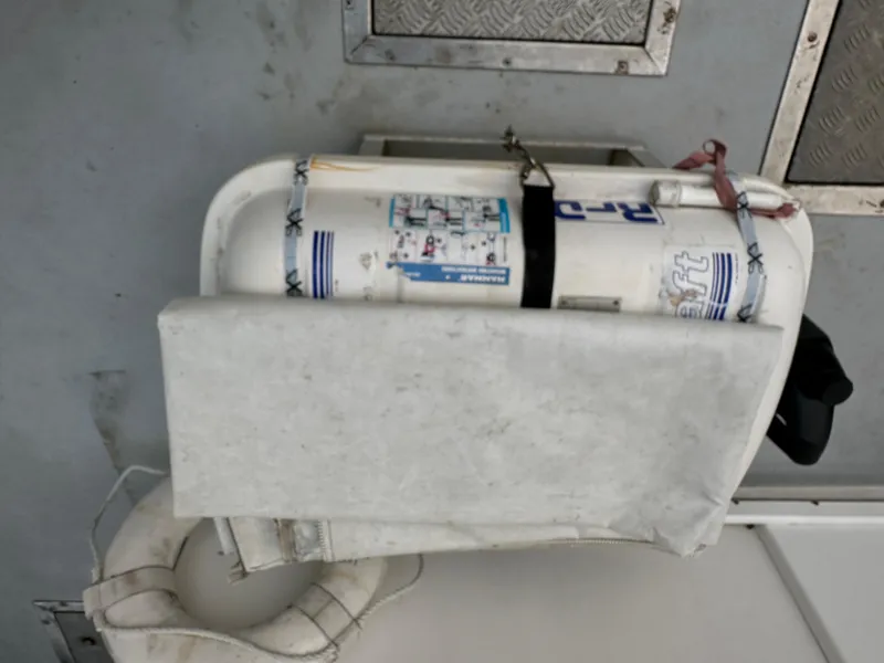 Slide: The Image of Life raft on 2003 BHM Sport Fish boat deck, secured with straps. - 10