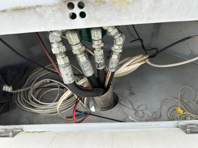 Slide: The Image of Wiring and hoses inside a 2003 BHM Sport Fish boat compartment. - 14