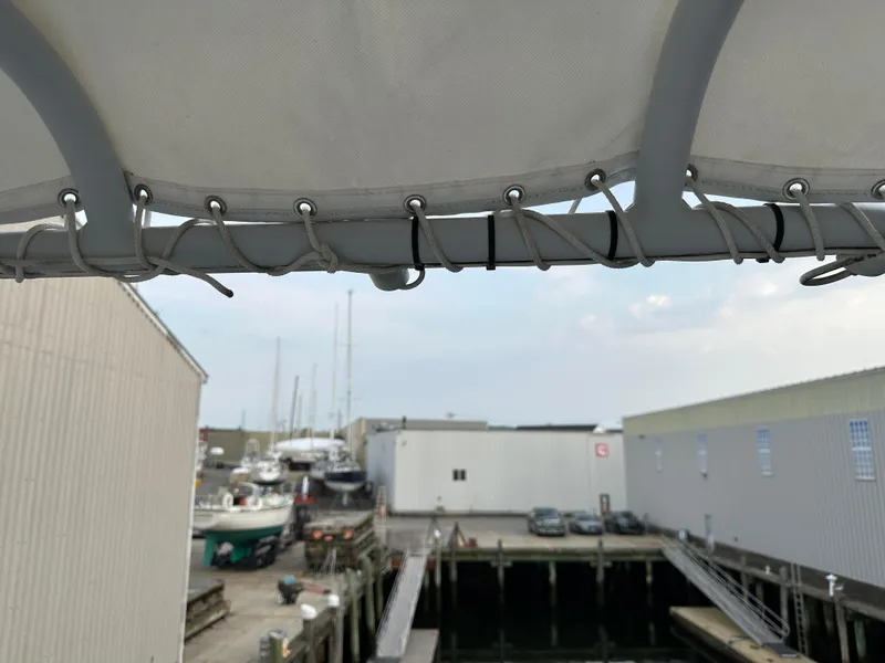 Slide: The Image of Boat canopy view at a marina with docked vessels and warehouses, BHM Sport Fish 2003. - 15