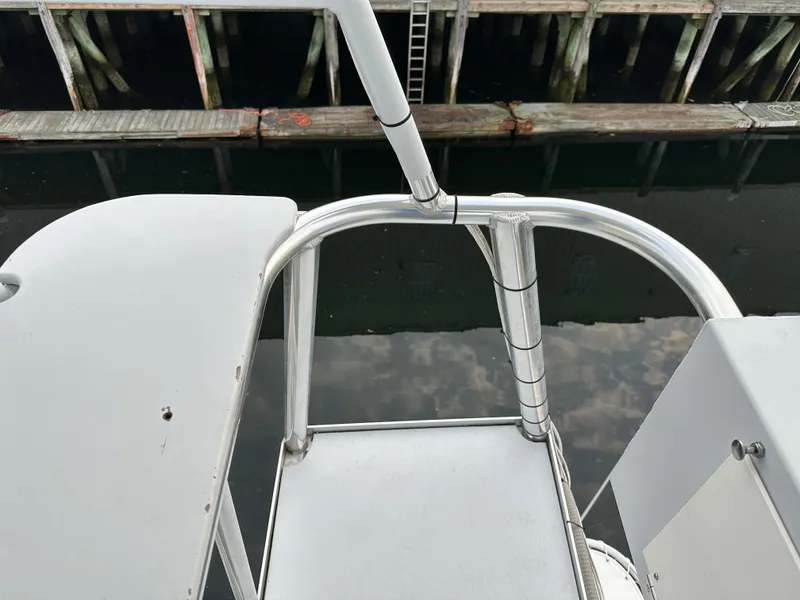 Slide: The Image of View from a 2003 BHM Sport Fish boat, showing railing and dock reflection. - 18