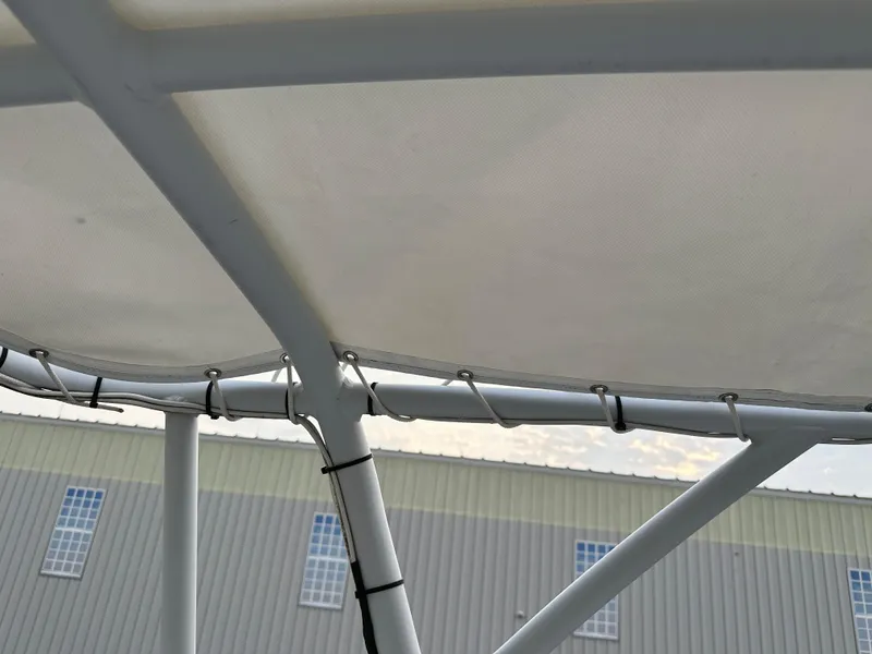 Slide: The Image of BHM Sport Fish 2003 boat canopy frame with building in background. - 19