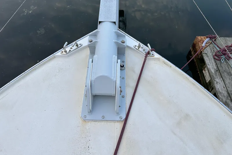 Slide: The Image of Bow of 2003 BHM Sport Fish boat docked, showing anchor mount and mooring lines. - 22