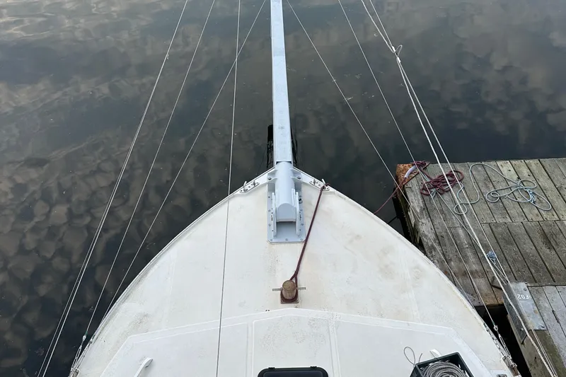 Slide: The Image of Bow of 2003 BHM Sport Fish boat docked by wooden pier. - 24