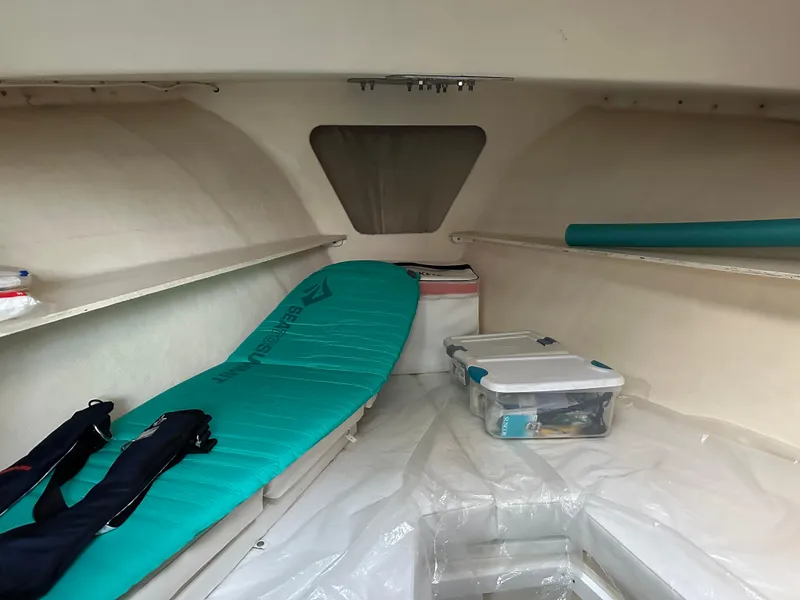 Slide: The Image of Interior cabin of 2003 BHM Sport Fish boat with storage and sleeping area. - 26
