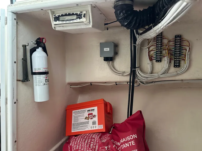 Slide: The Image of Electrical panel and safety equipment inside a 2003 BHM Sport Fish boat. - 29