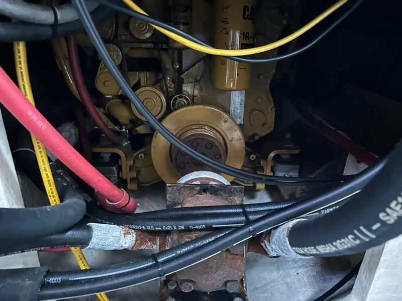 Slide: The Image of Engine compartment of a 2003 BHM Sport Fish boat with visible cables and components. - 30