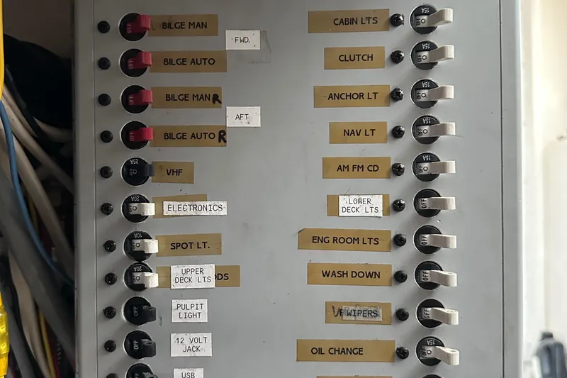 Slide: The Image of Electrical panel with labeled switches for various boat functions on a 2003 BHM Sport Fish. - 32